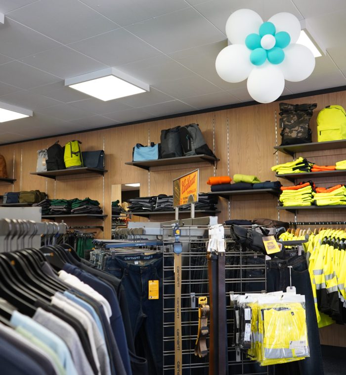 Innenansicht eines Bekleidungsgeschäfts mit Warnschutzkleidung, T-Shirts, Rucksäcken und Arbeitshosen bei MP Berufsbekleidung